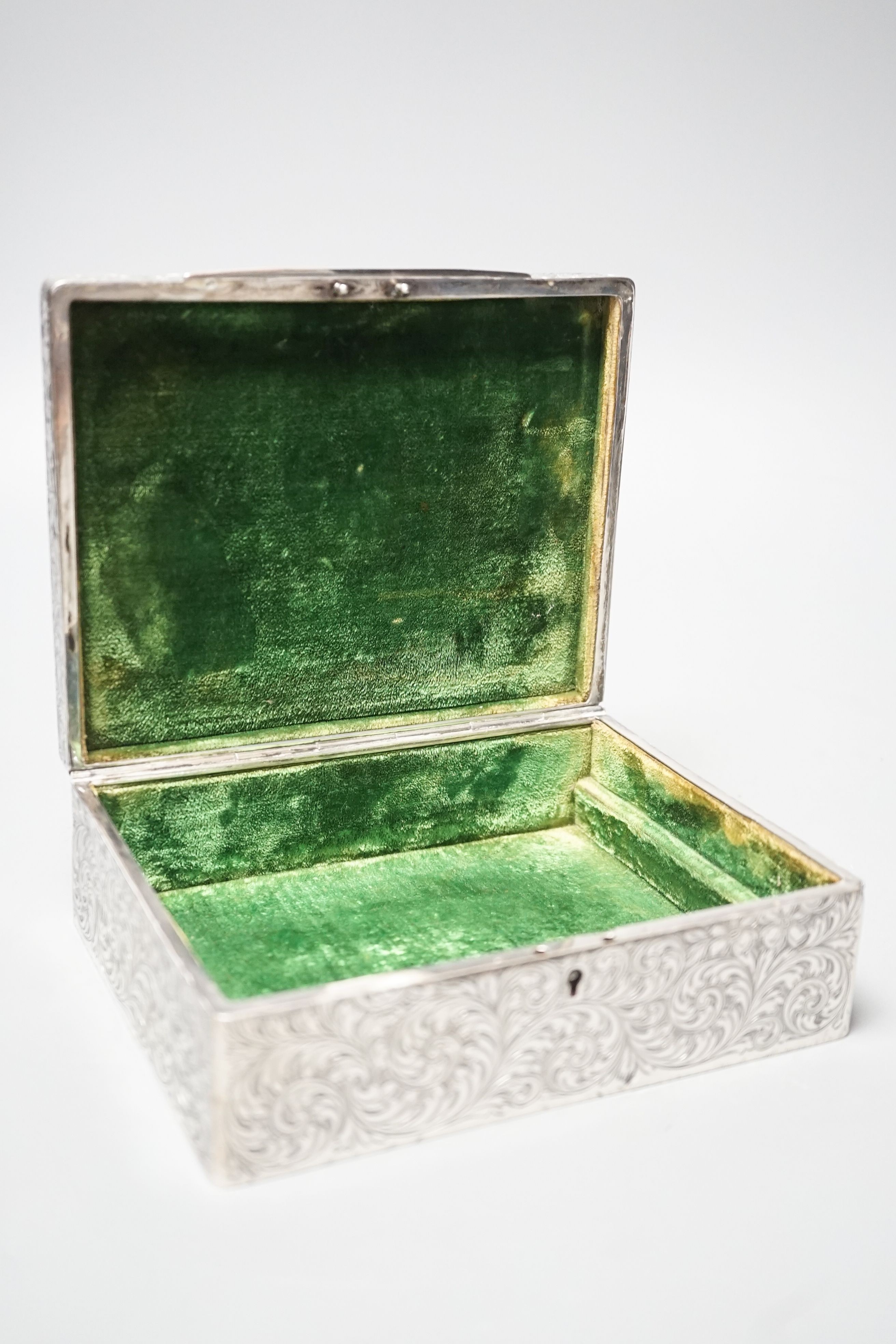 An engraved sterling rectangular box, with later added foliate mount, 16cm.